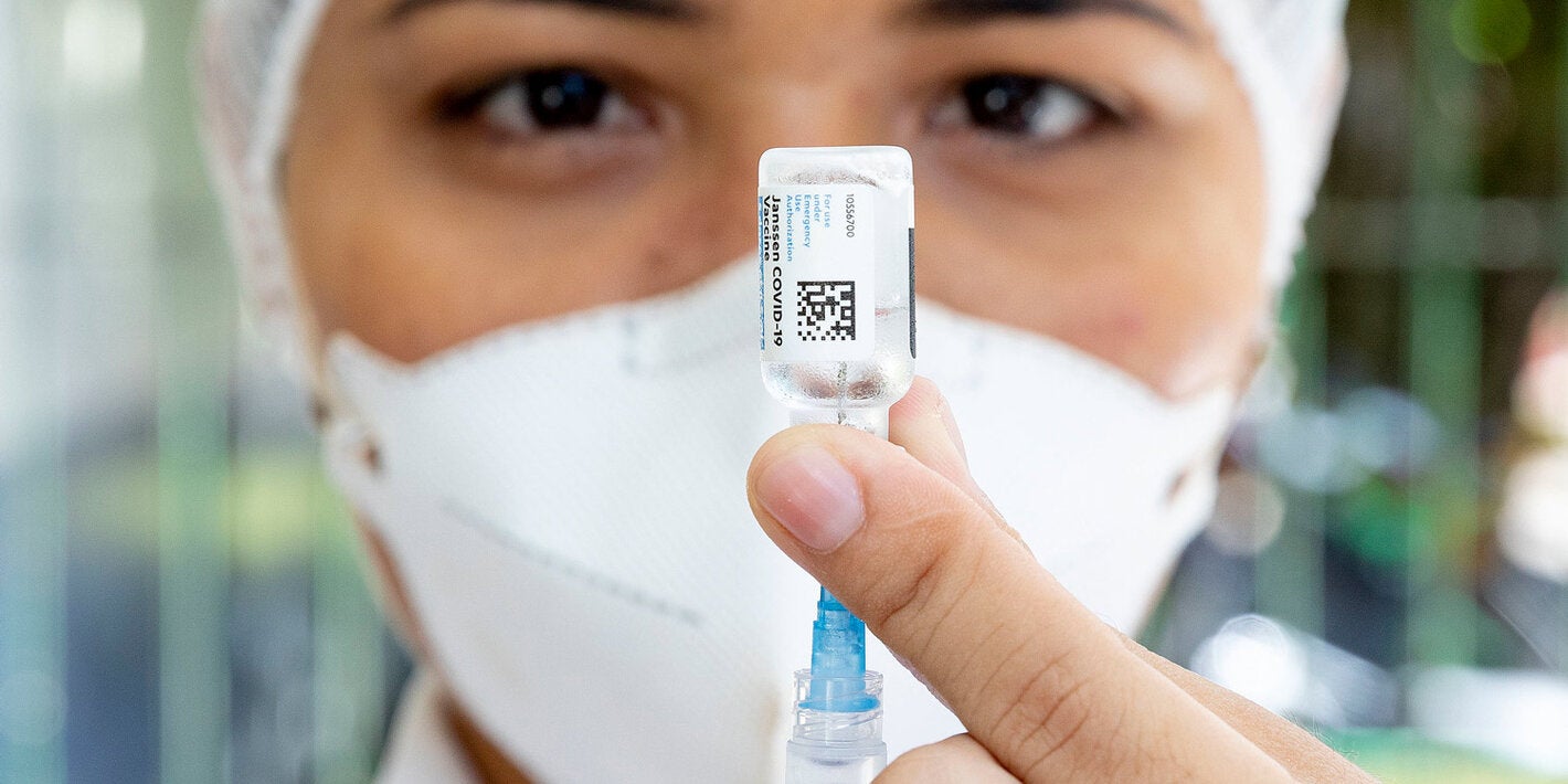 Health worker with COVID-19 vaccine in hand