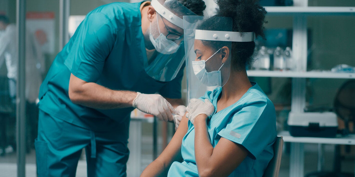 health worker getting vaccinated
