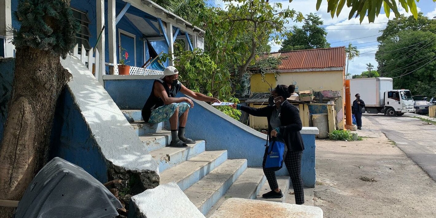 Healthcare worker sharing a vaccine pop-up flyer to a resident.