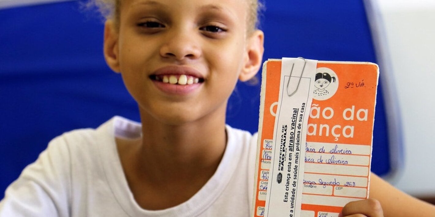 Young girl shows her HPV vaccination certificate in Brazil