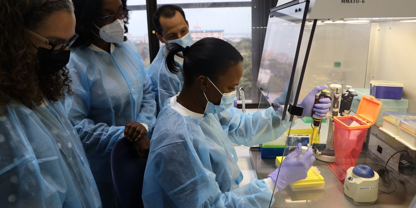 (L-R)  Dr. Valeska Stempliuk, Valeska Stempliuk - Advisor, Health Surveillance, Disease Prevention and Control, PAHO/ WHO Office for Jamaica, Bermuda & The Cayman Islands;  Dr. Michelle Hamilton, Director of the National Public Health Laboratory and Dr. Lionel Gresh, Virologist at PAHO Headquarters in Washington looks on as Ms. Cindy Thomas, Senior Medical Technologist at the National Public Health Laboratory conducts a diagnostic test on the Monkeypox virus.
