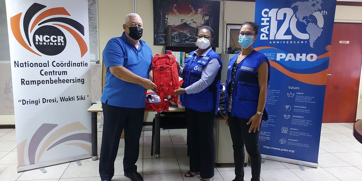 NCCR Coordinator Lt. Col Jerry Slijngard, PAHO Representative Dr. Karen Lewis-Bell, and PAHO National Consultant Astrid van Sauers