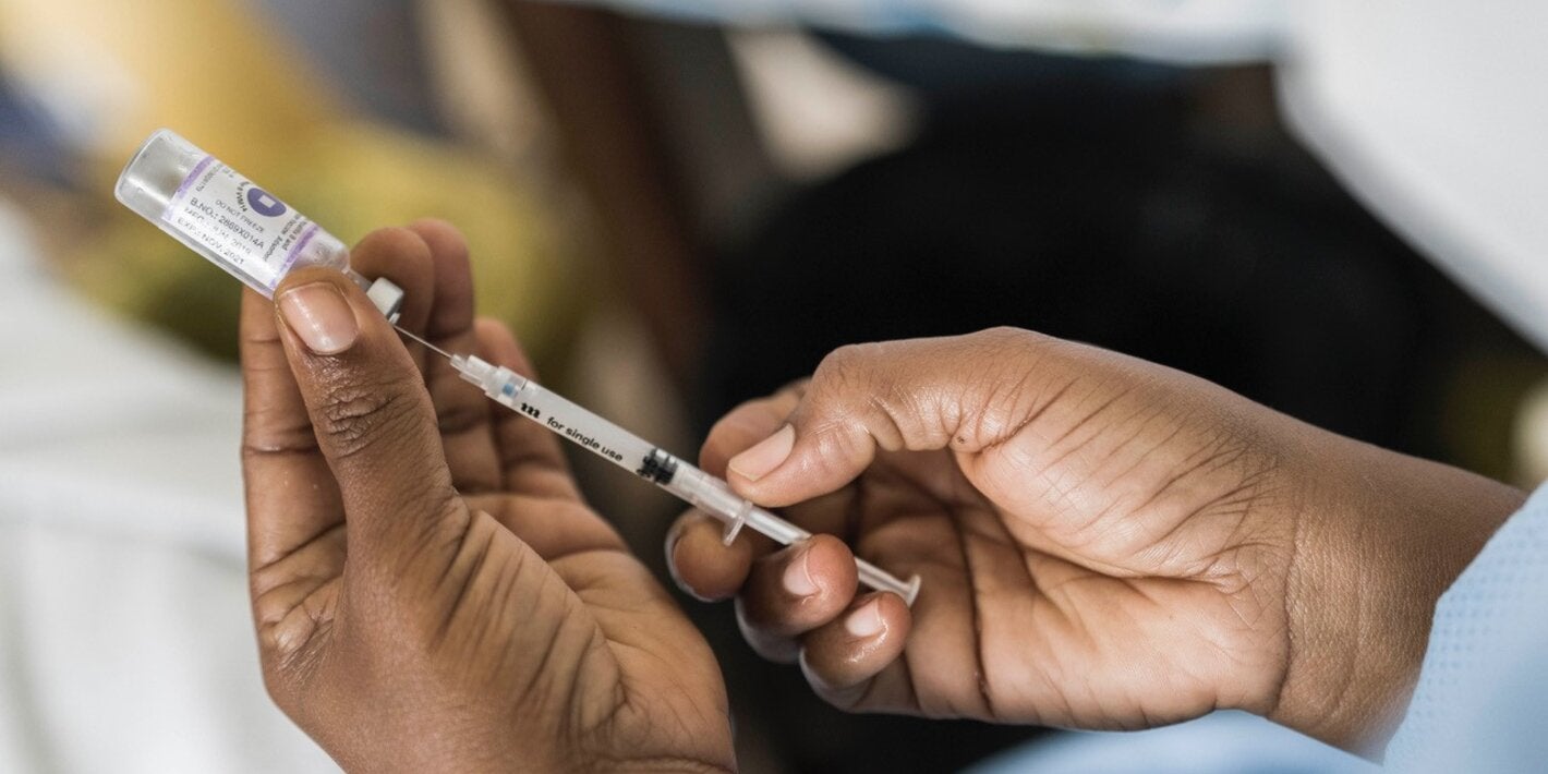 Health workers holds COVID-19 vaccine