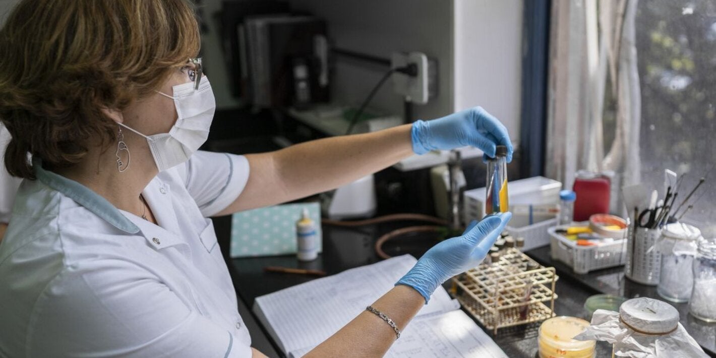 generic female lab tecnician with test tubes