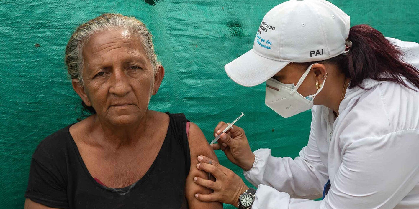 Older adult receives vaccine.