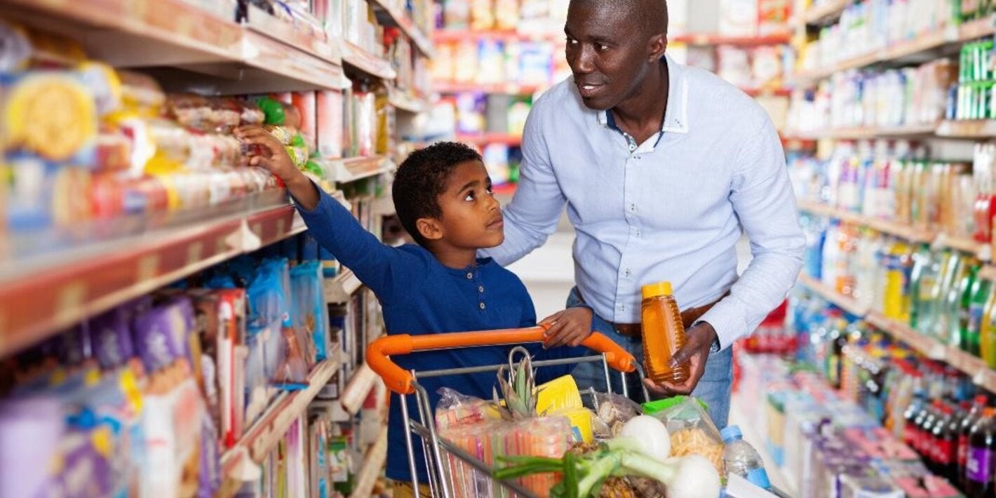 Boy and father selecting products at the supermarket