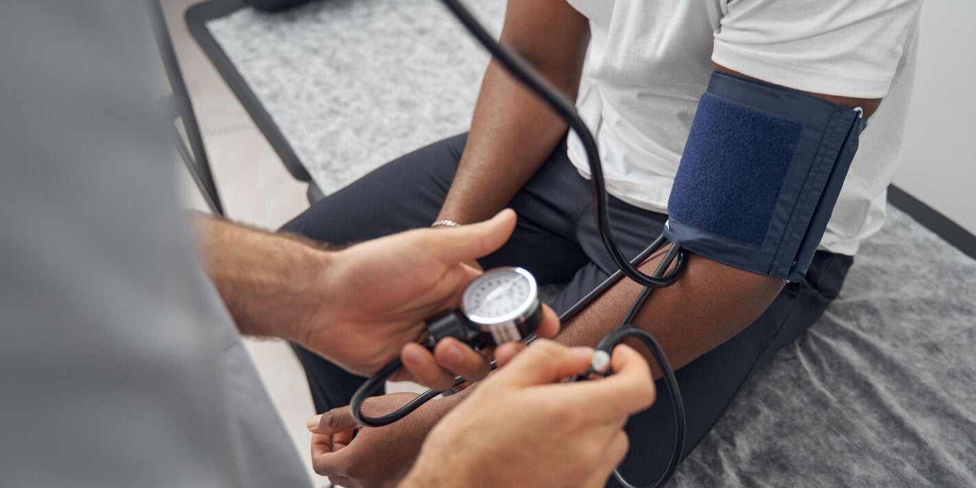 Doctor checks patient's blood pressure