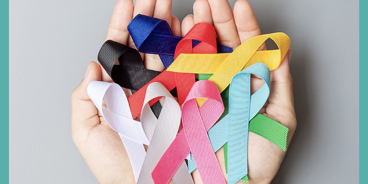 Hands with ribbon of the different colors representing various cancer types
