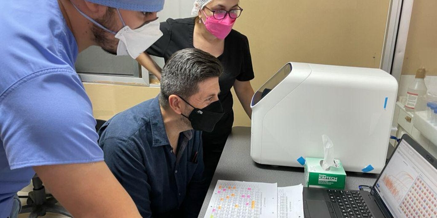 jairo mendez being shown data on a laptop