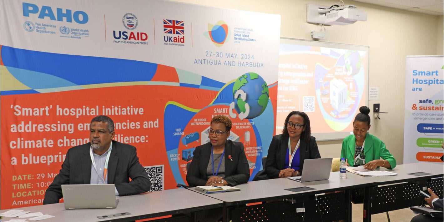 2 women, emergency medical team members, checking their supplies inside the movil hospital