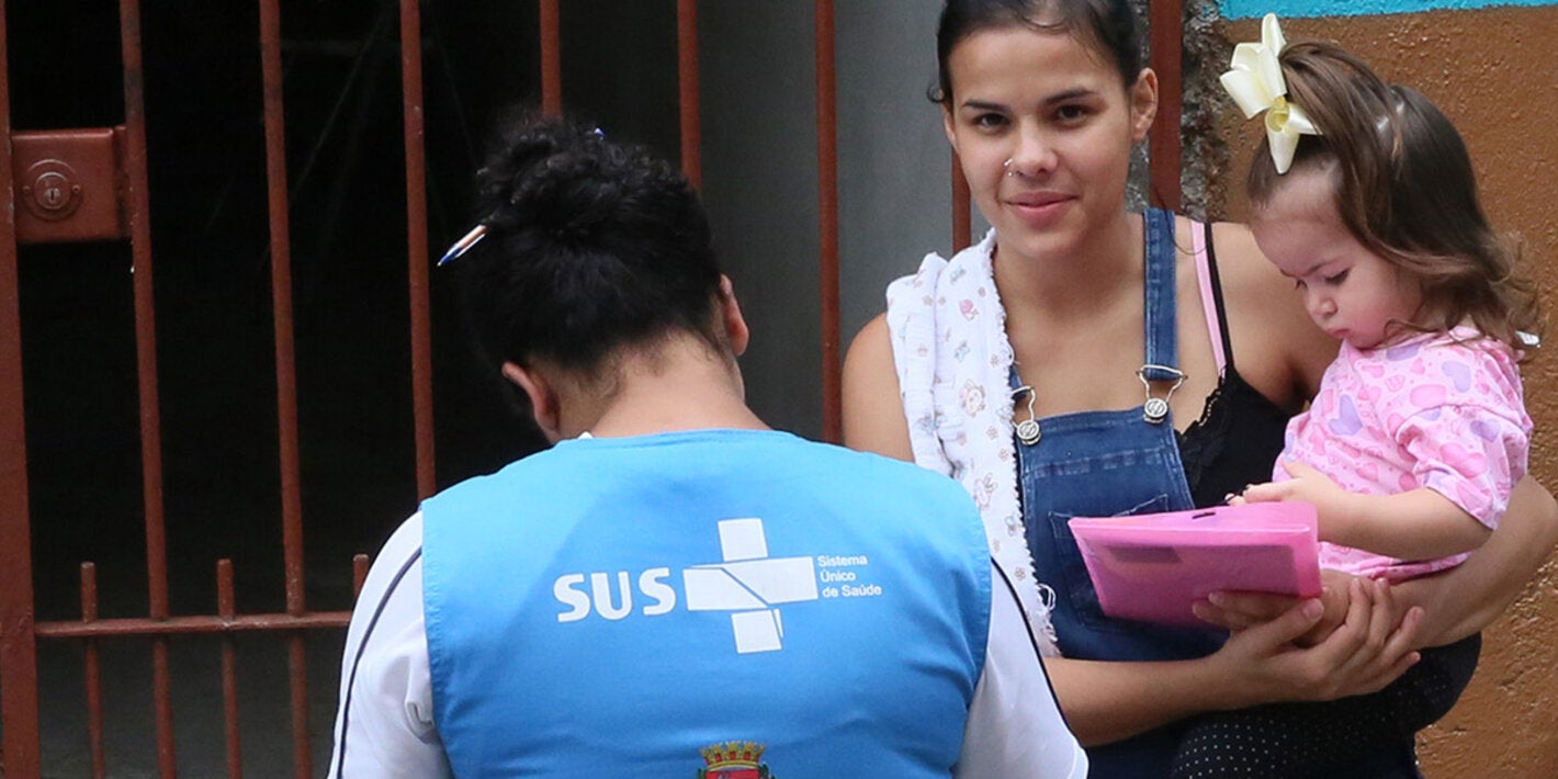 woman in a door holding a child