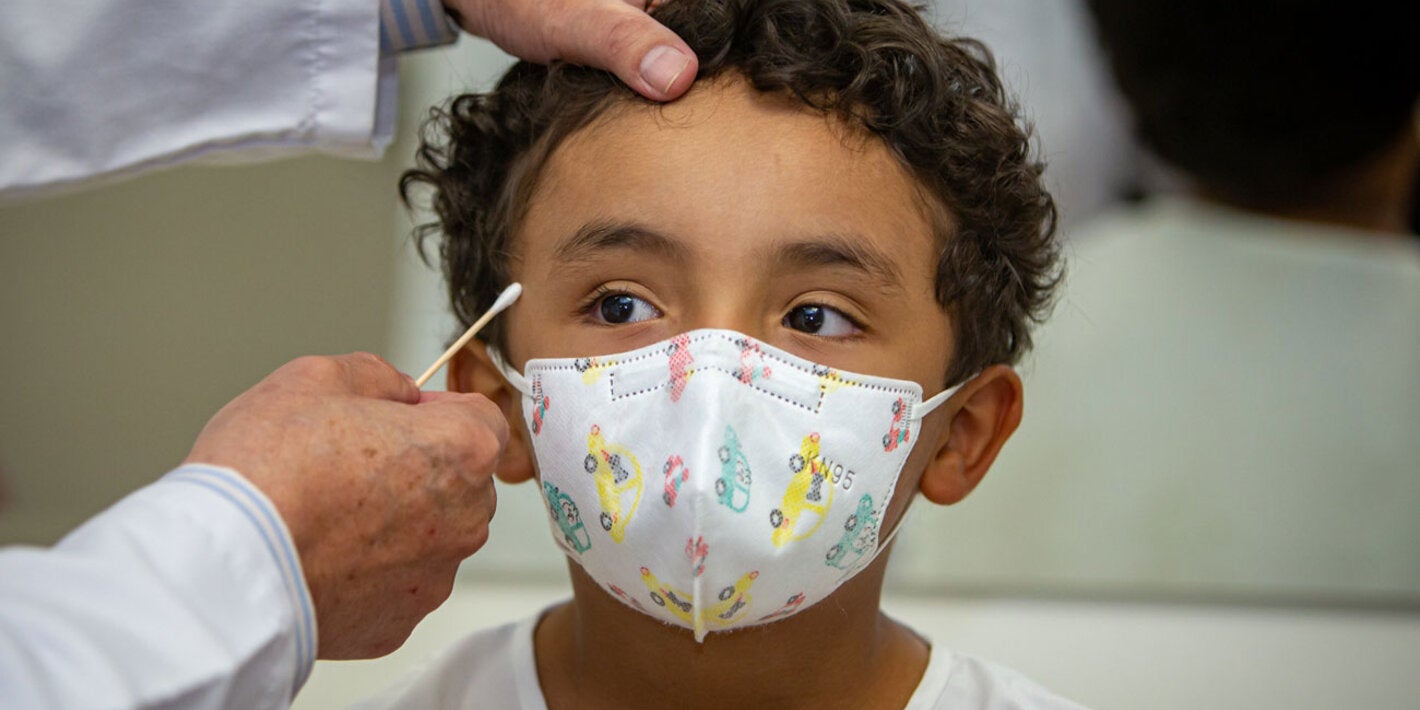 Doctor measures the head circumference of a child.