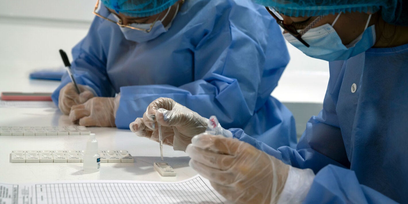 Health workers with test kits in a lab
