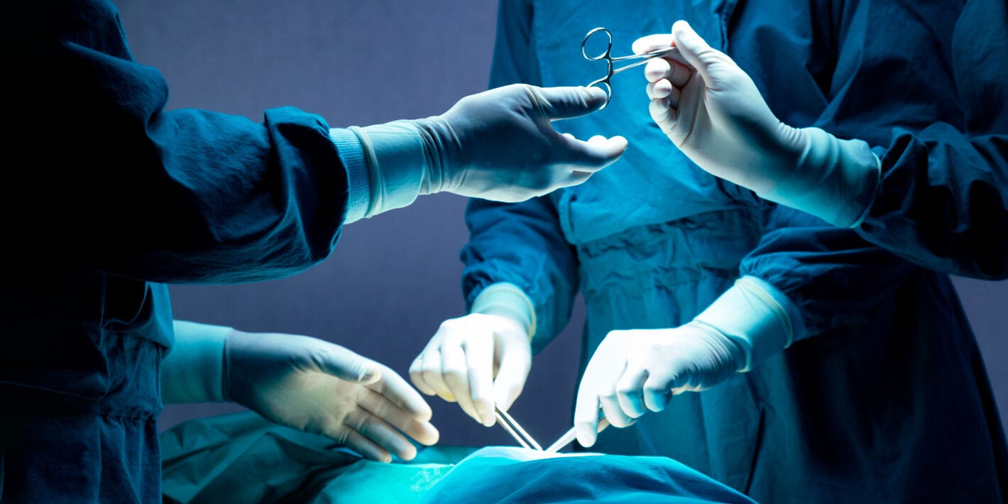 Operating room. Physicians and nurese holding surgical instruments