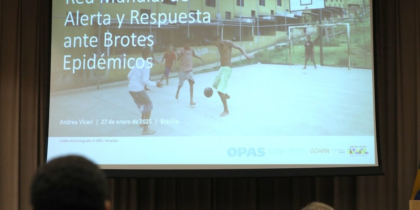 Participants watch presentation about outbreaks during the training