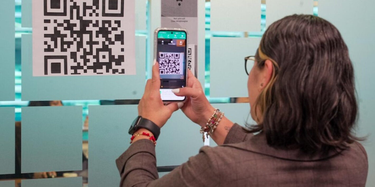 PAHO official takes photo of QR code