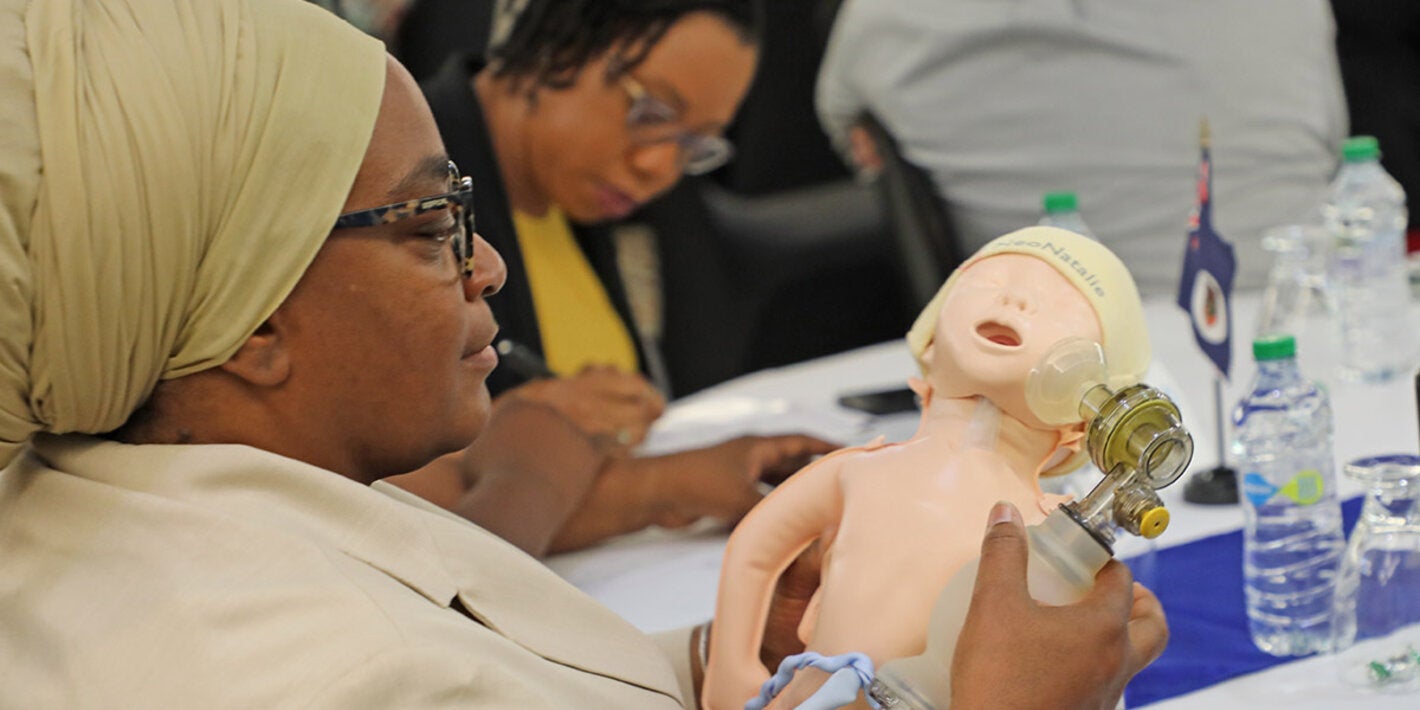 Conference participant looking at model of a baby