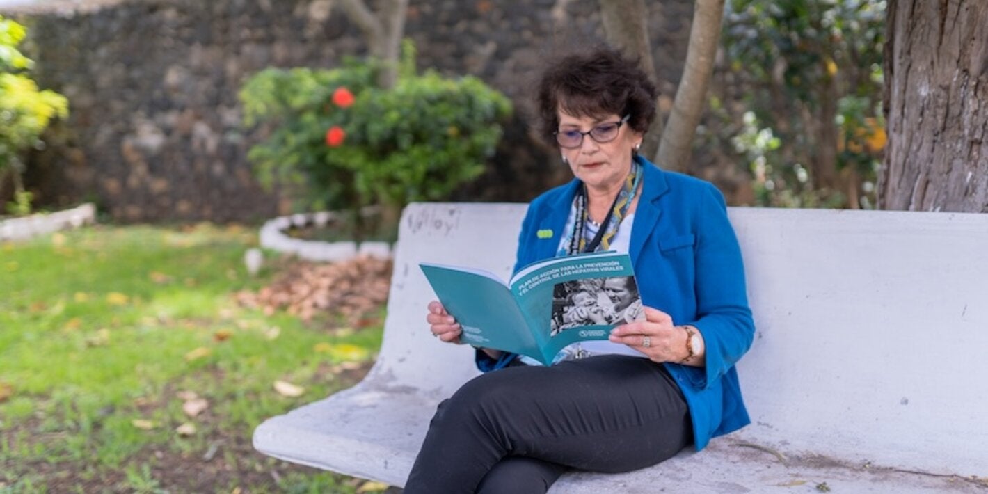 Lady sitting on bench reading