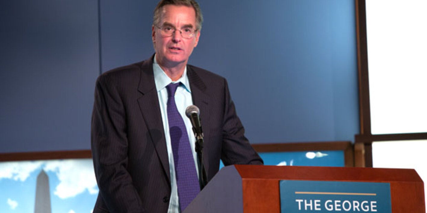 Dr. Anderson speaks behind a podium at GWU