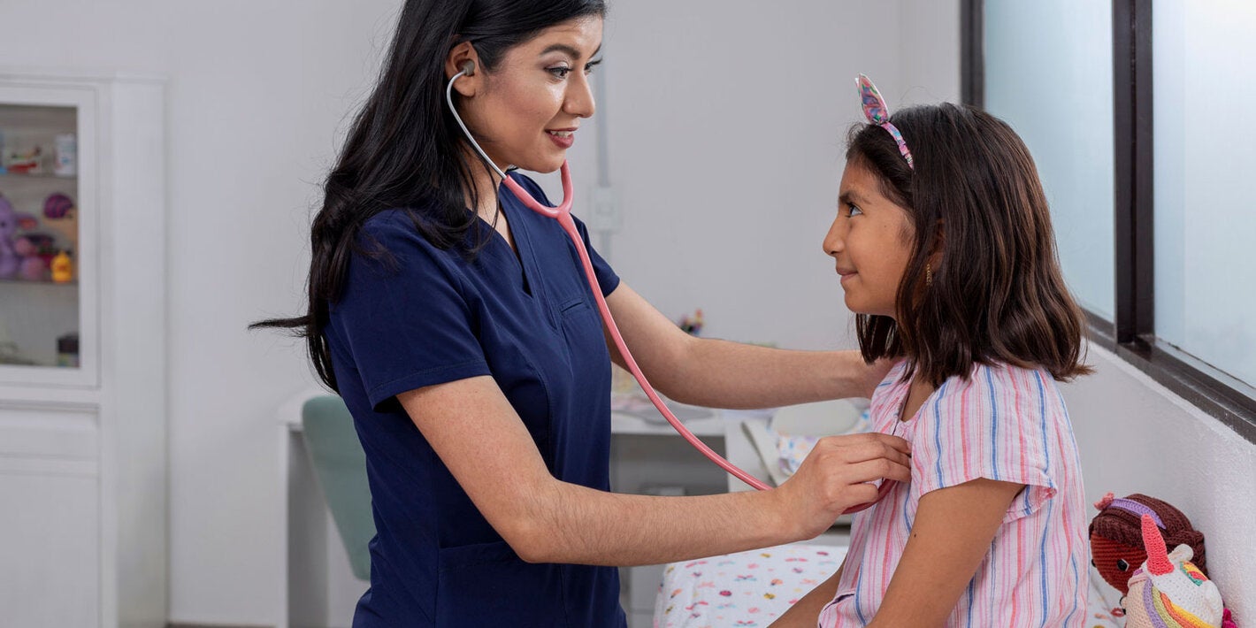Nurse conducting a health checkup of a girl