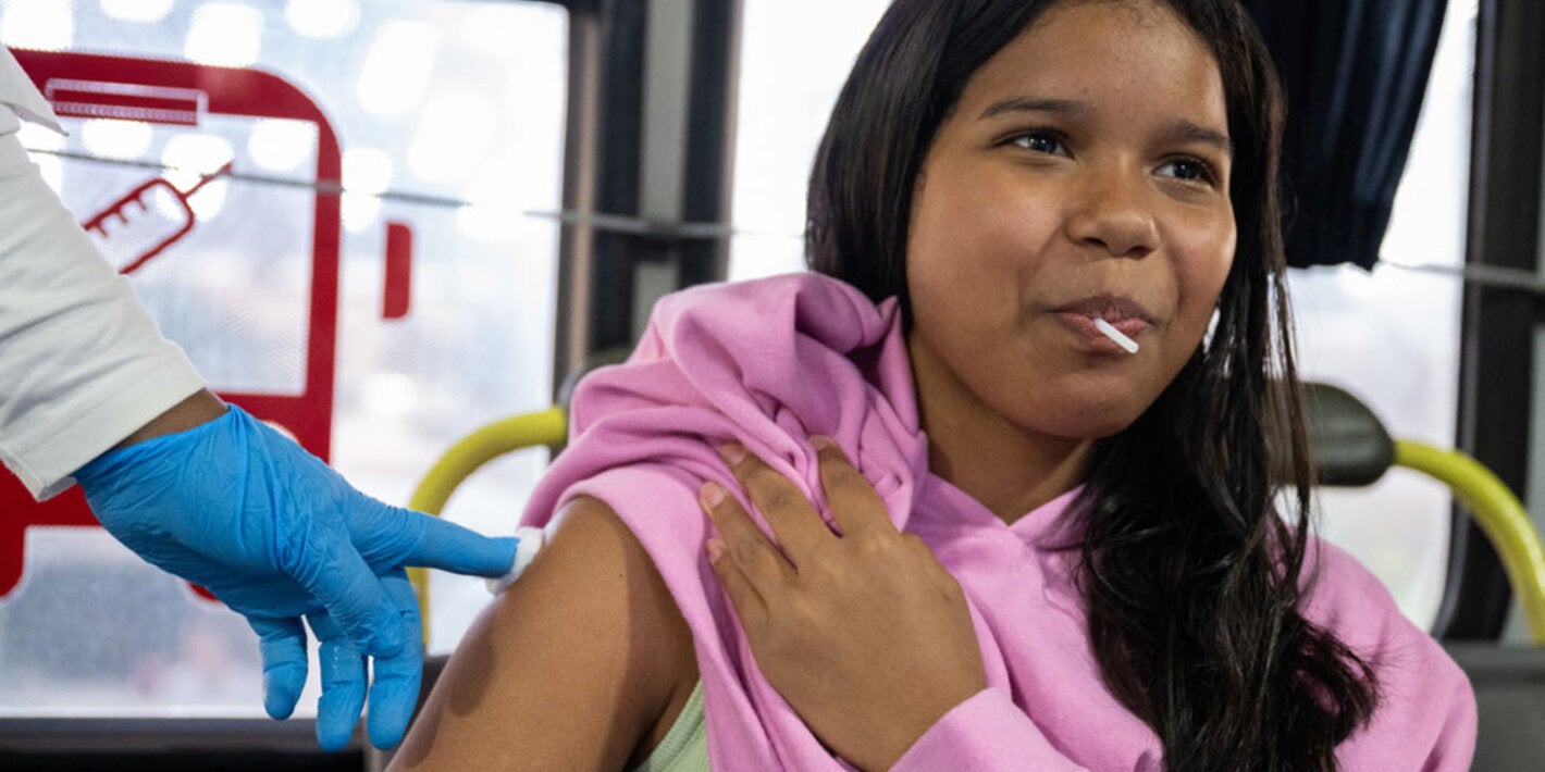 Mujer colocando el braso para la vacuna de fiebre amarilla