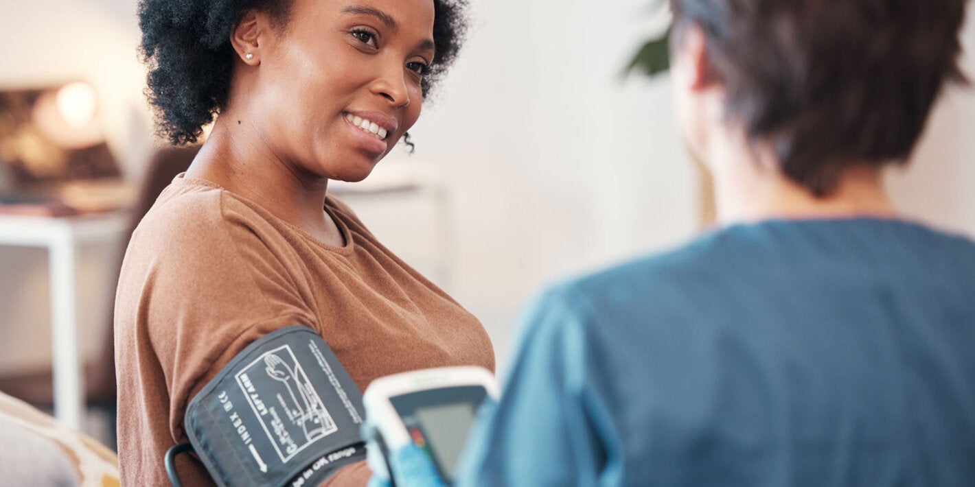 Woman having her blood pressure checked