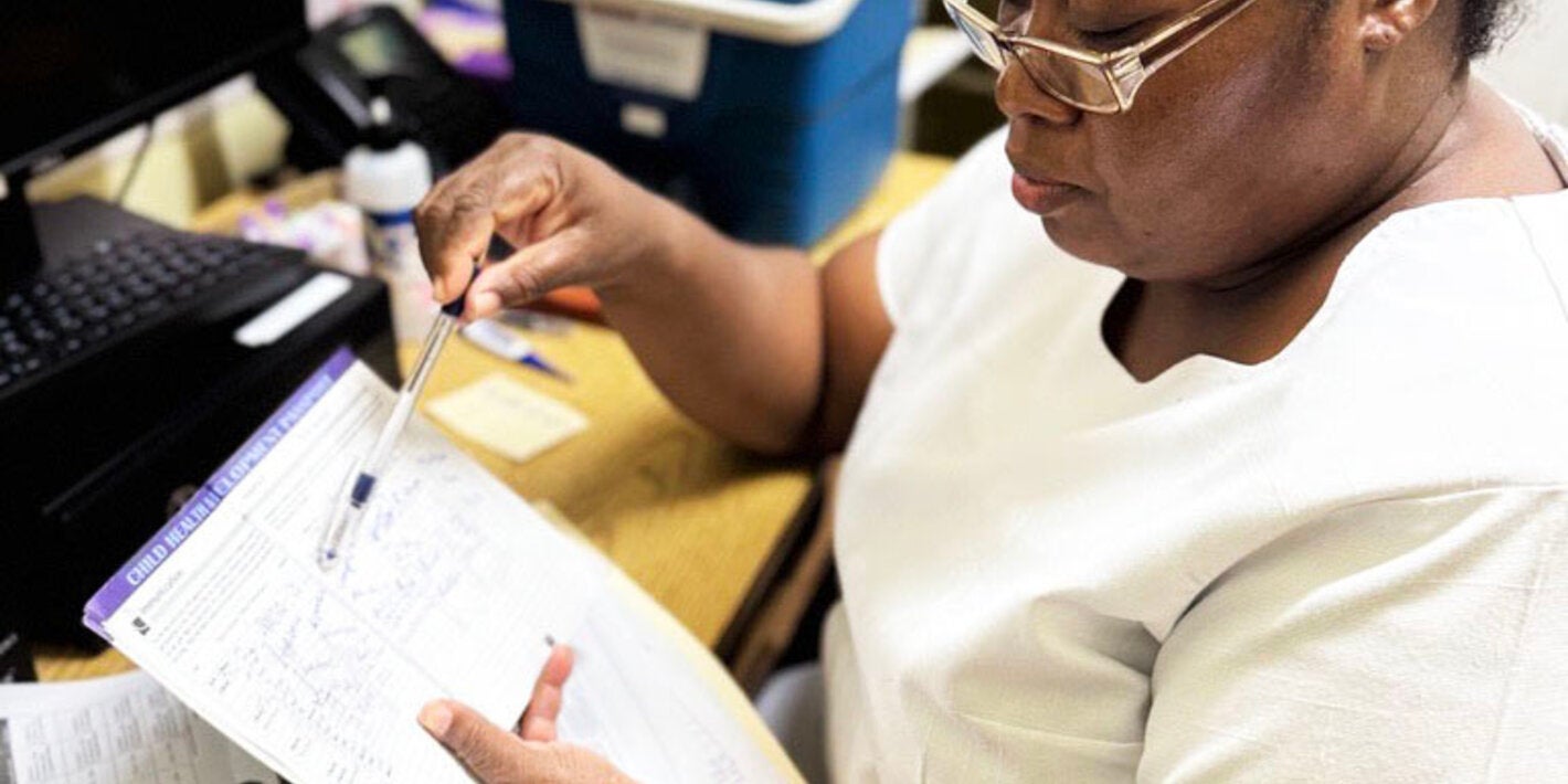 nurse reviews vaccine data