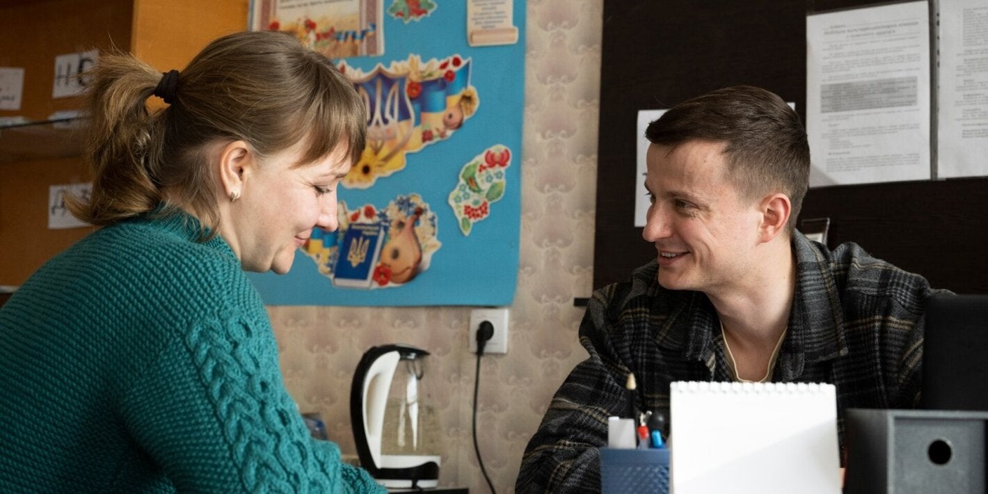 man and woman smile as they talk