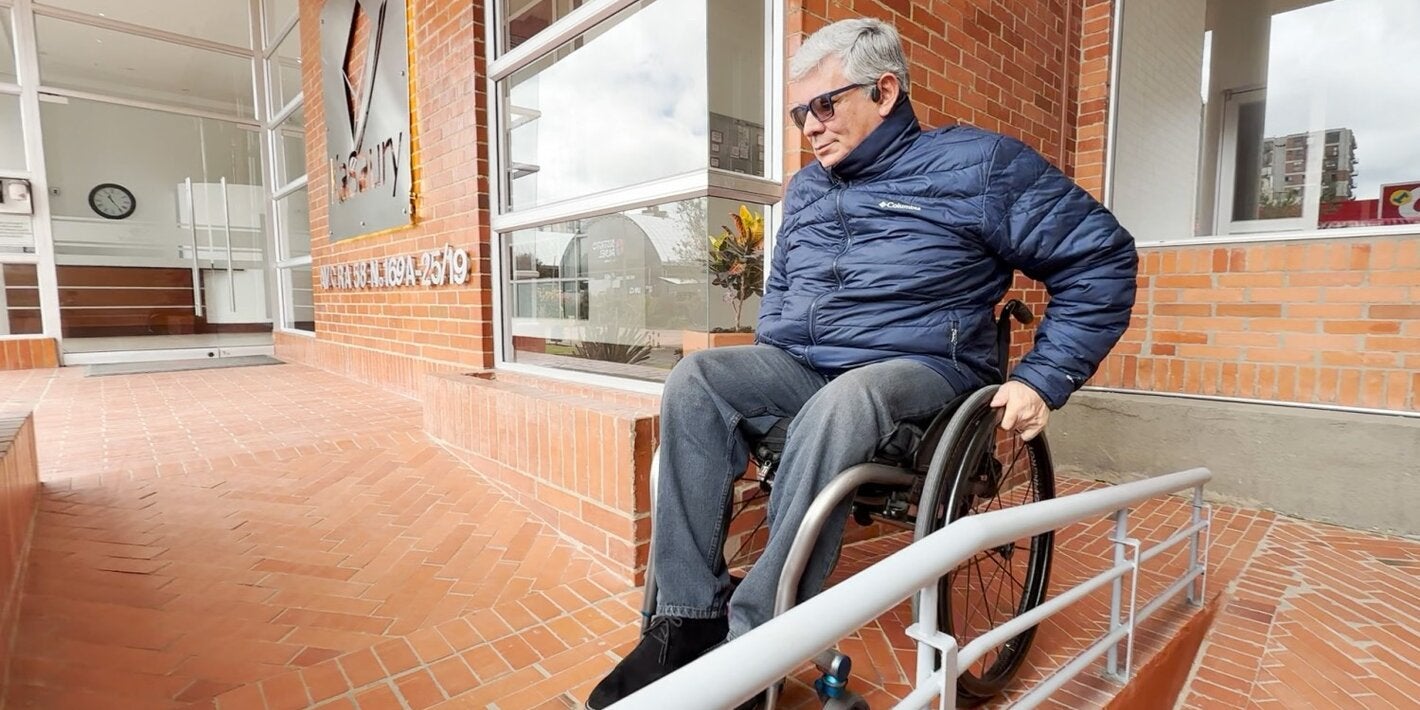 Ricardo on a wheelchair navigating a ramp