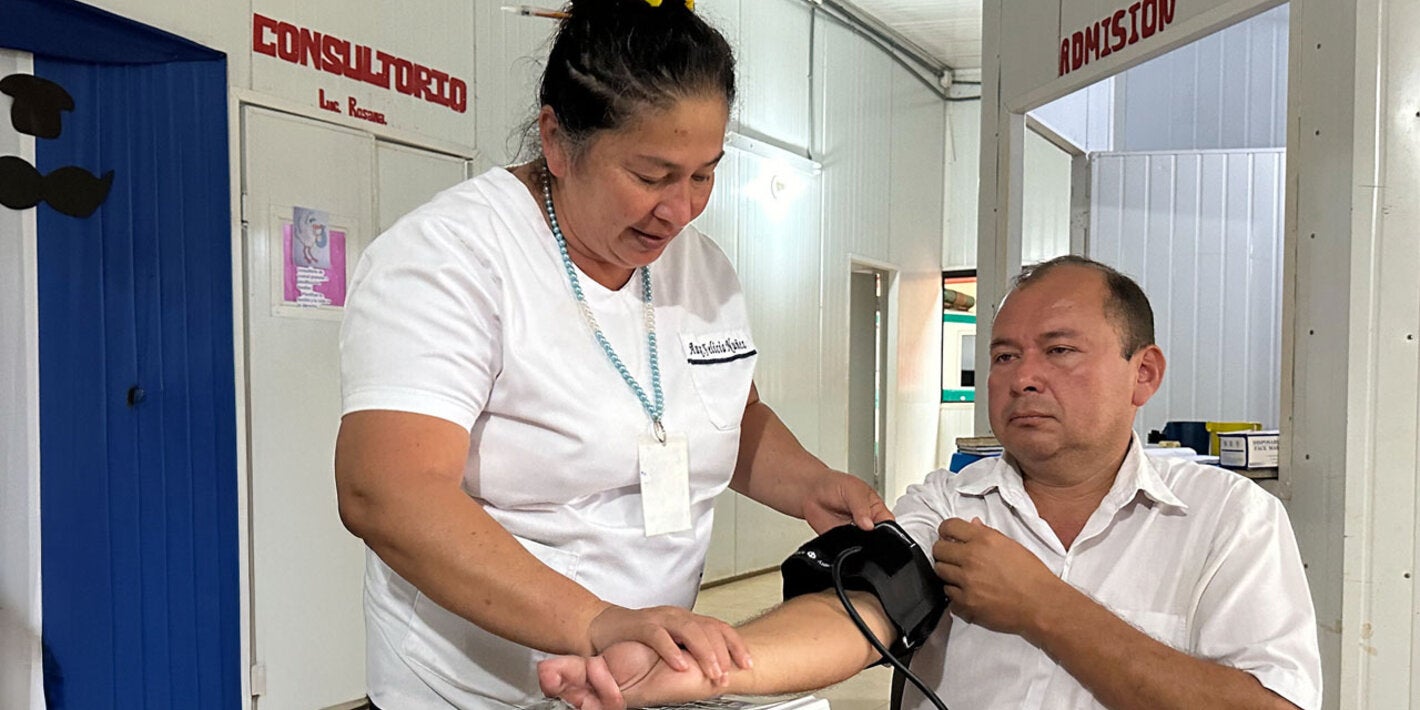 Patient at health centerchecks his blood pressure