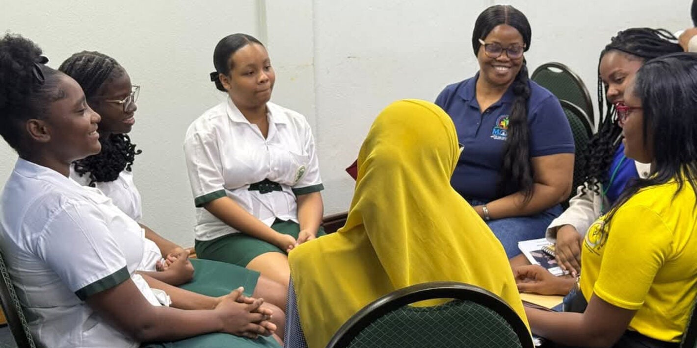 Youth around the table with adults addressing issues