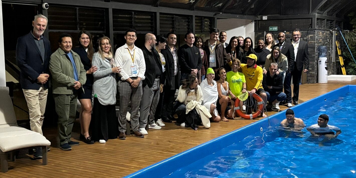 people standing by the pool