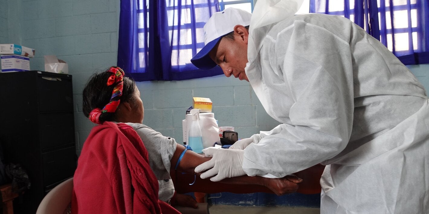 Personal de salud hace prueba de laboratorio a mujer maya