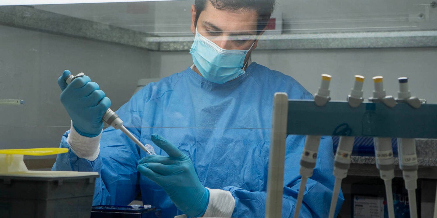 technician in protective gear testing and tracking down viruses