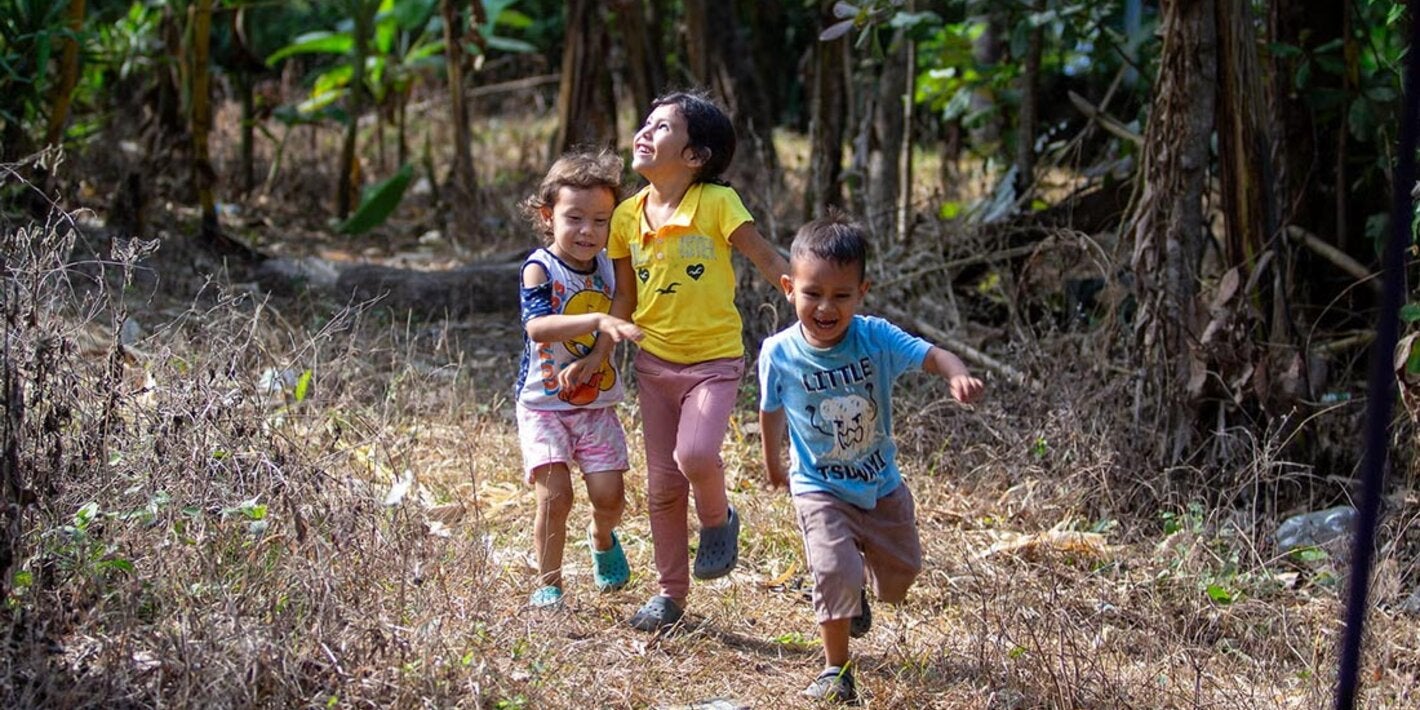 Children running through the fields