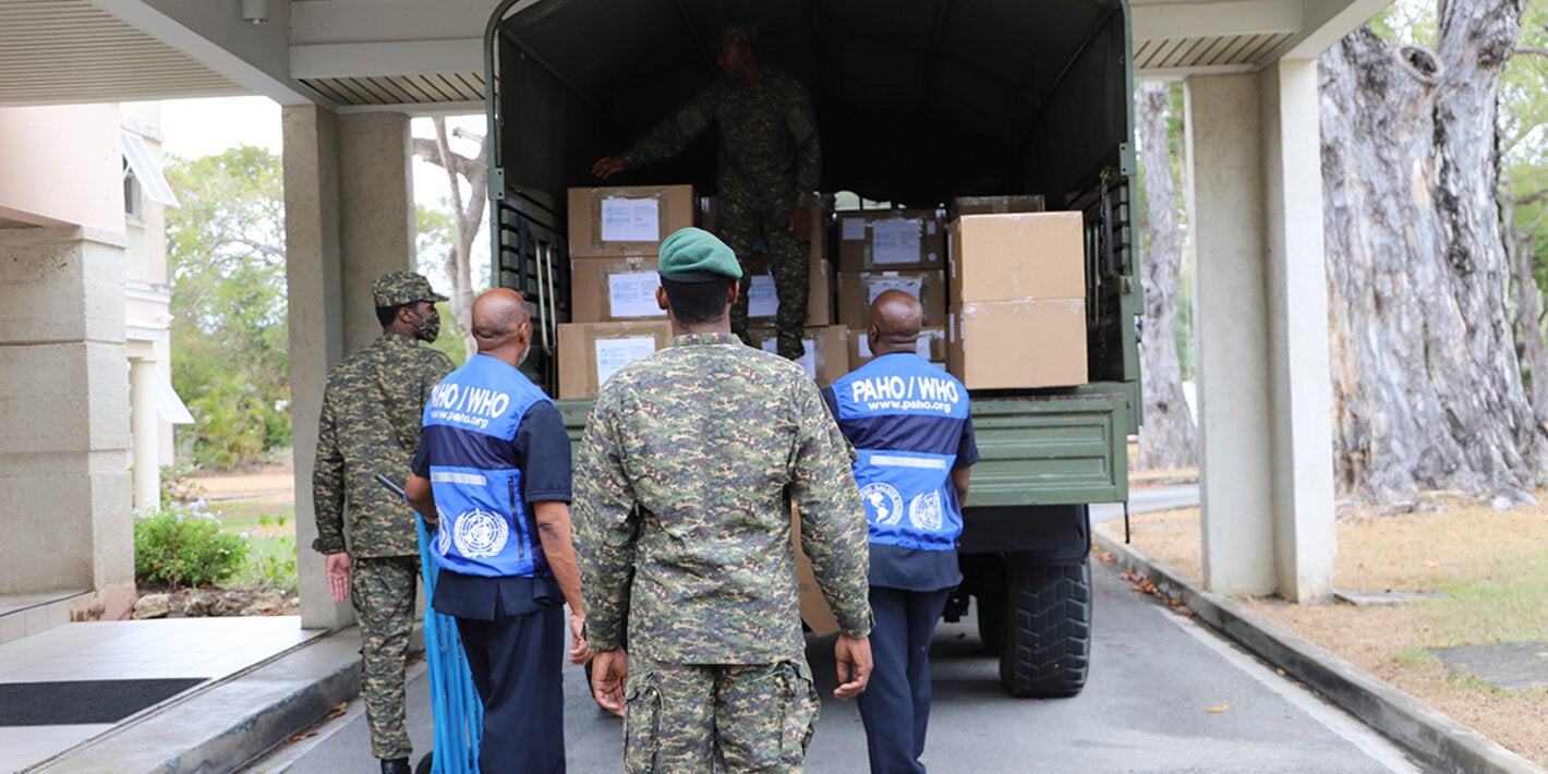 PAHO and Barbados Defence Force personnel loading truck with donated items