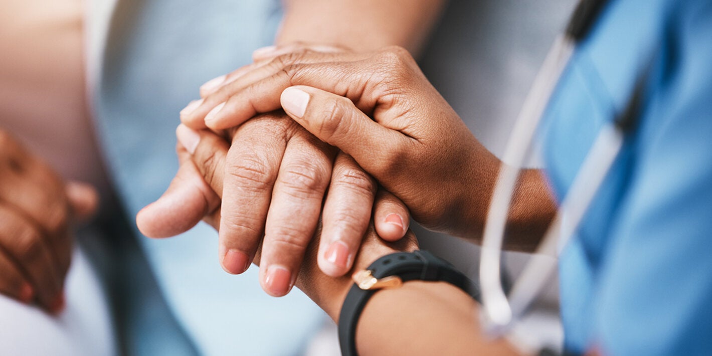 Health worker holding the hand of a patient