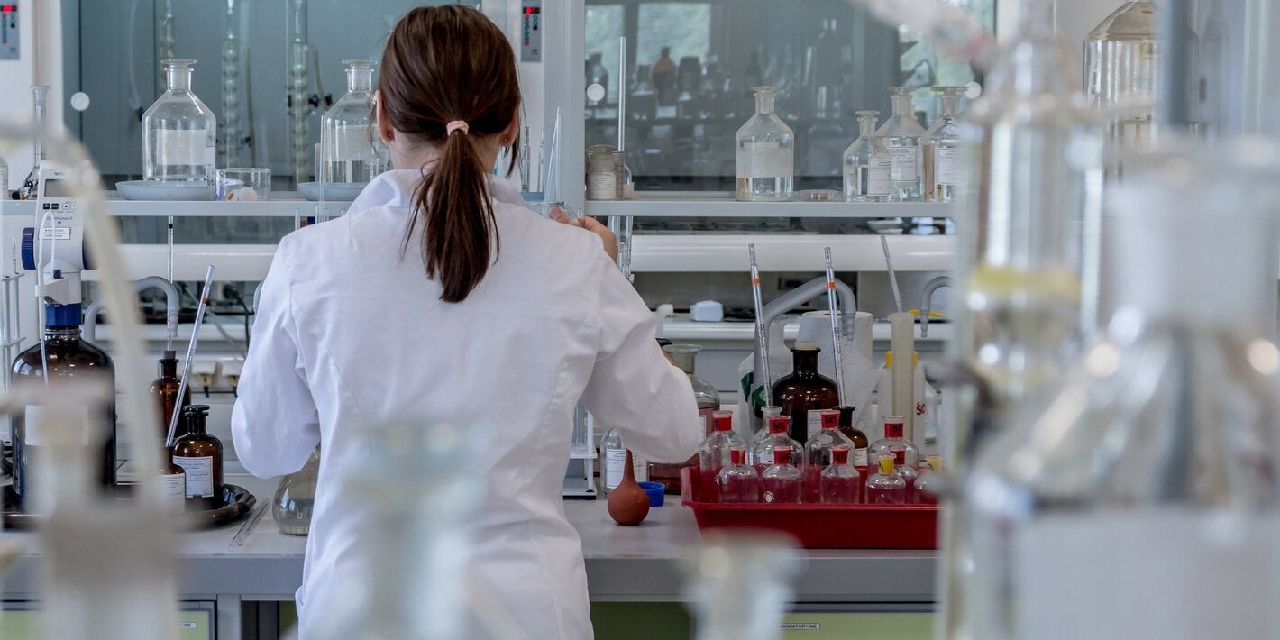Woman backing camera in laboratory.