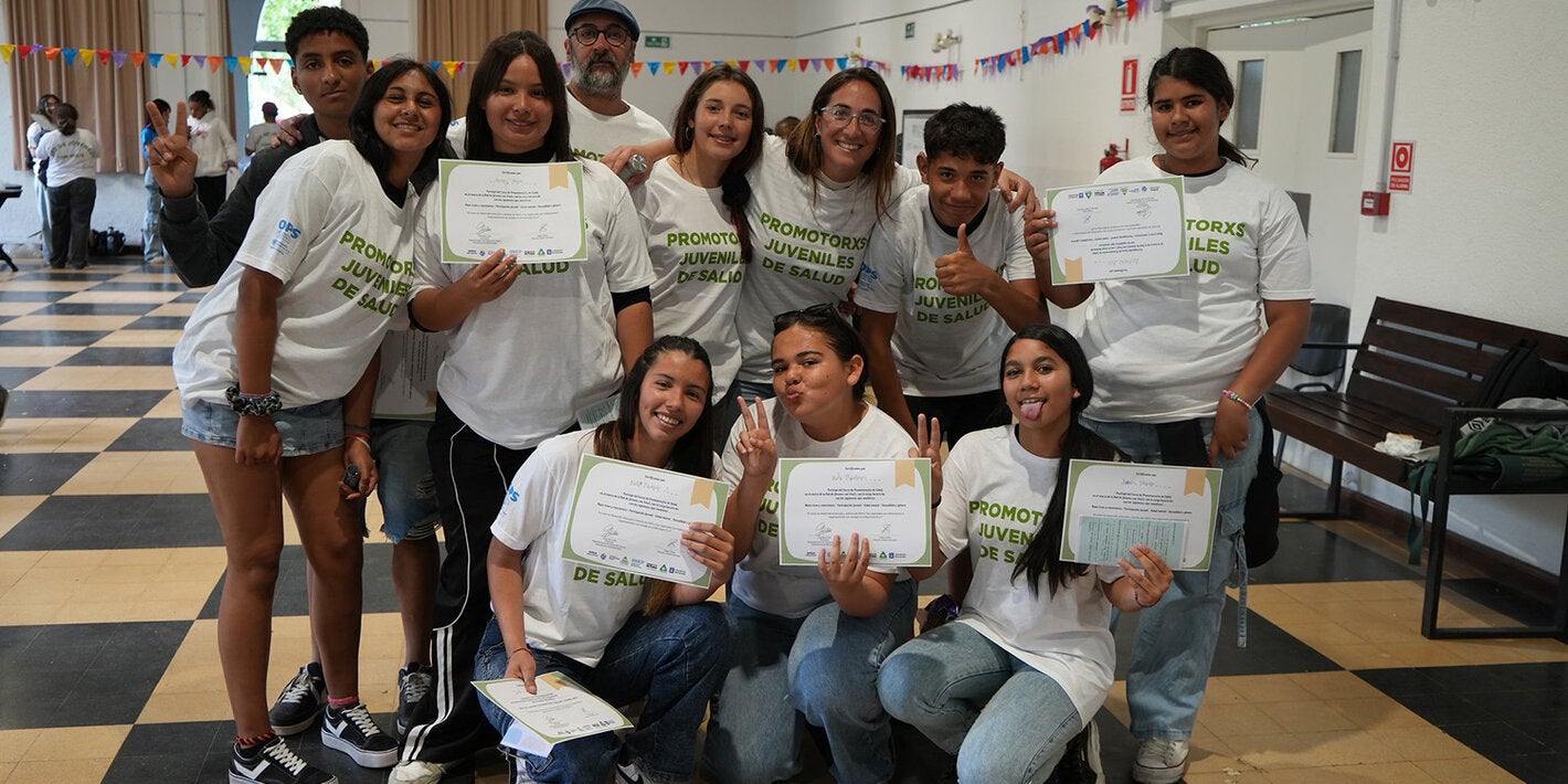 Young participants group photo holding up certificates