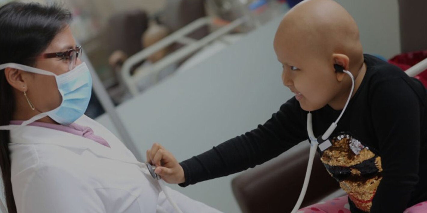 child with cancer interacting with doctor