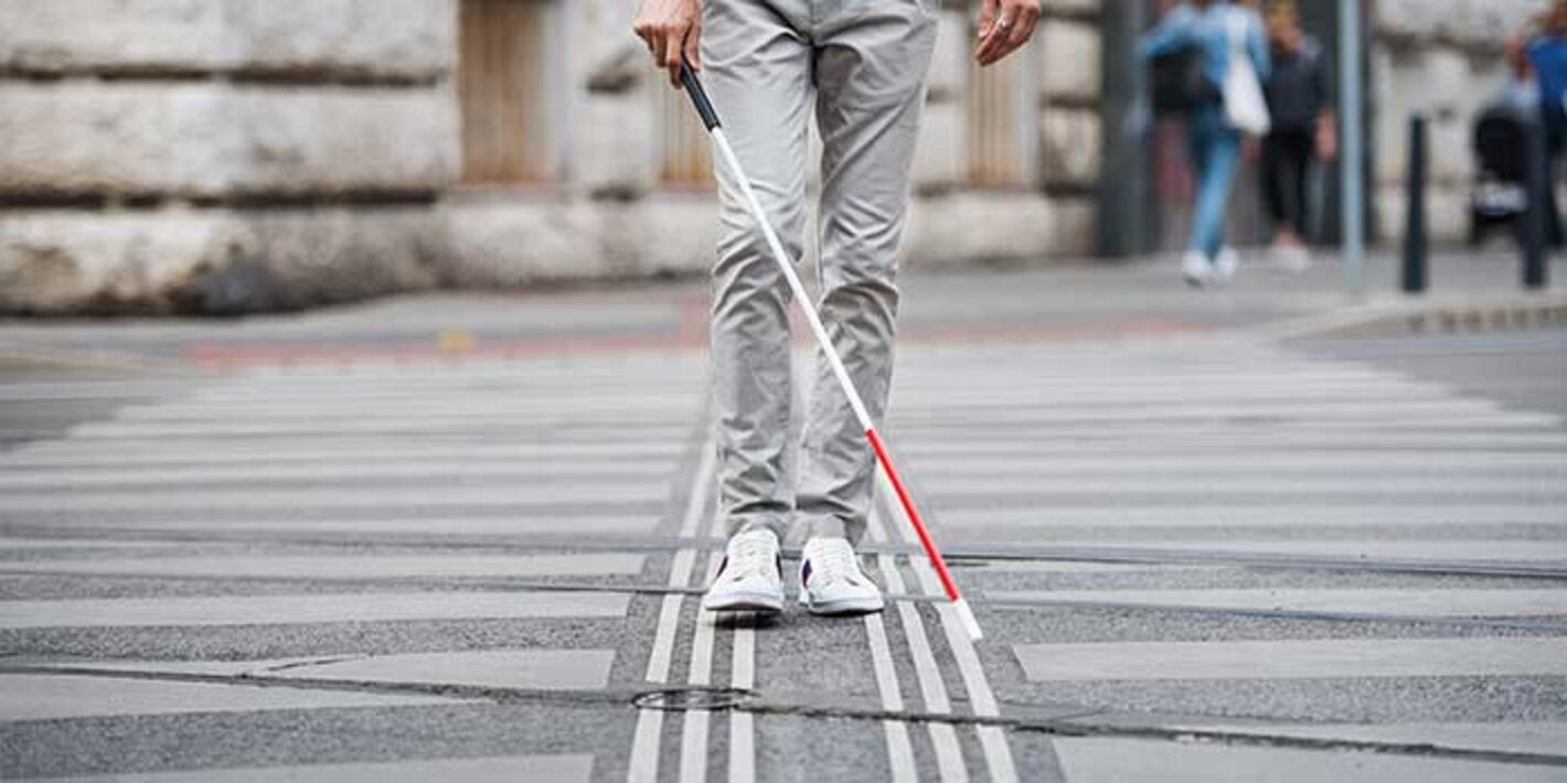 blind man walking on road
