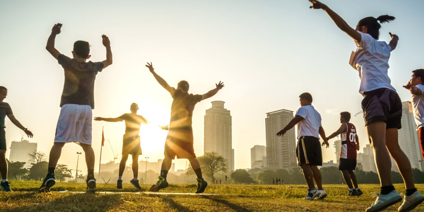 Group of people exercising in open space