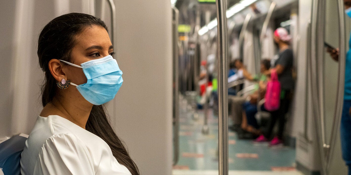 Woman wearing mask while using public transportation