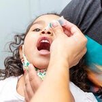 Child receives polio vaccine