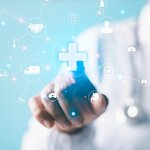 burred photo of the body of a health provider pointing at icons representing health