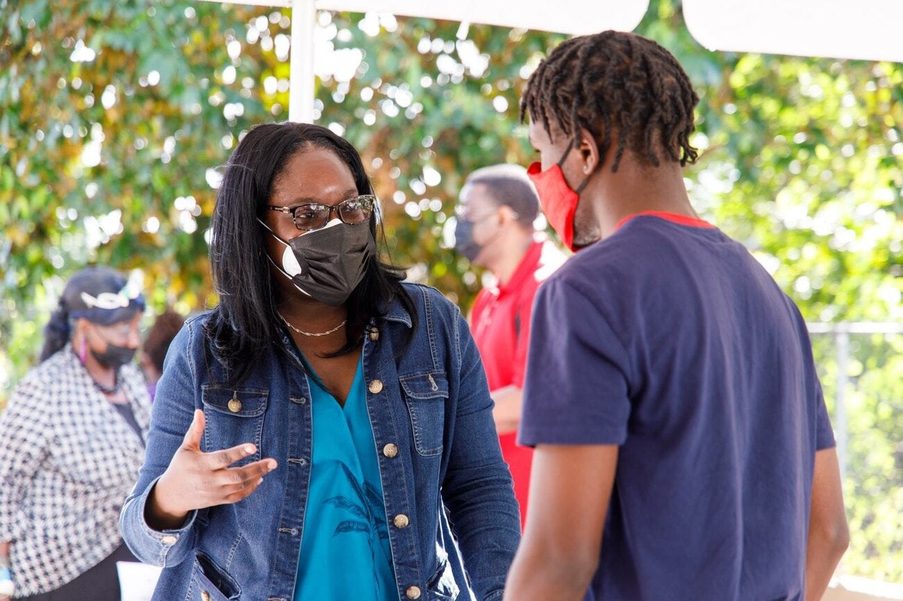 Health promotion officer answers the COVID-19 questions of a young resident.