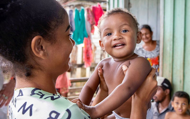 Mom holding happy baby