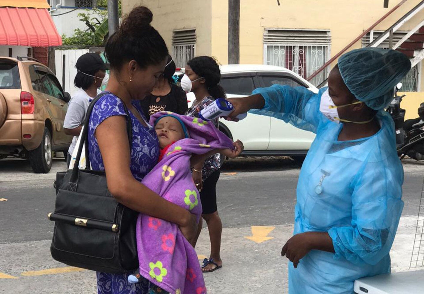 health worker taking temperature