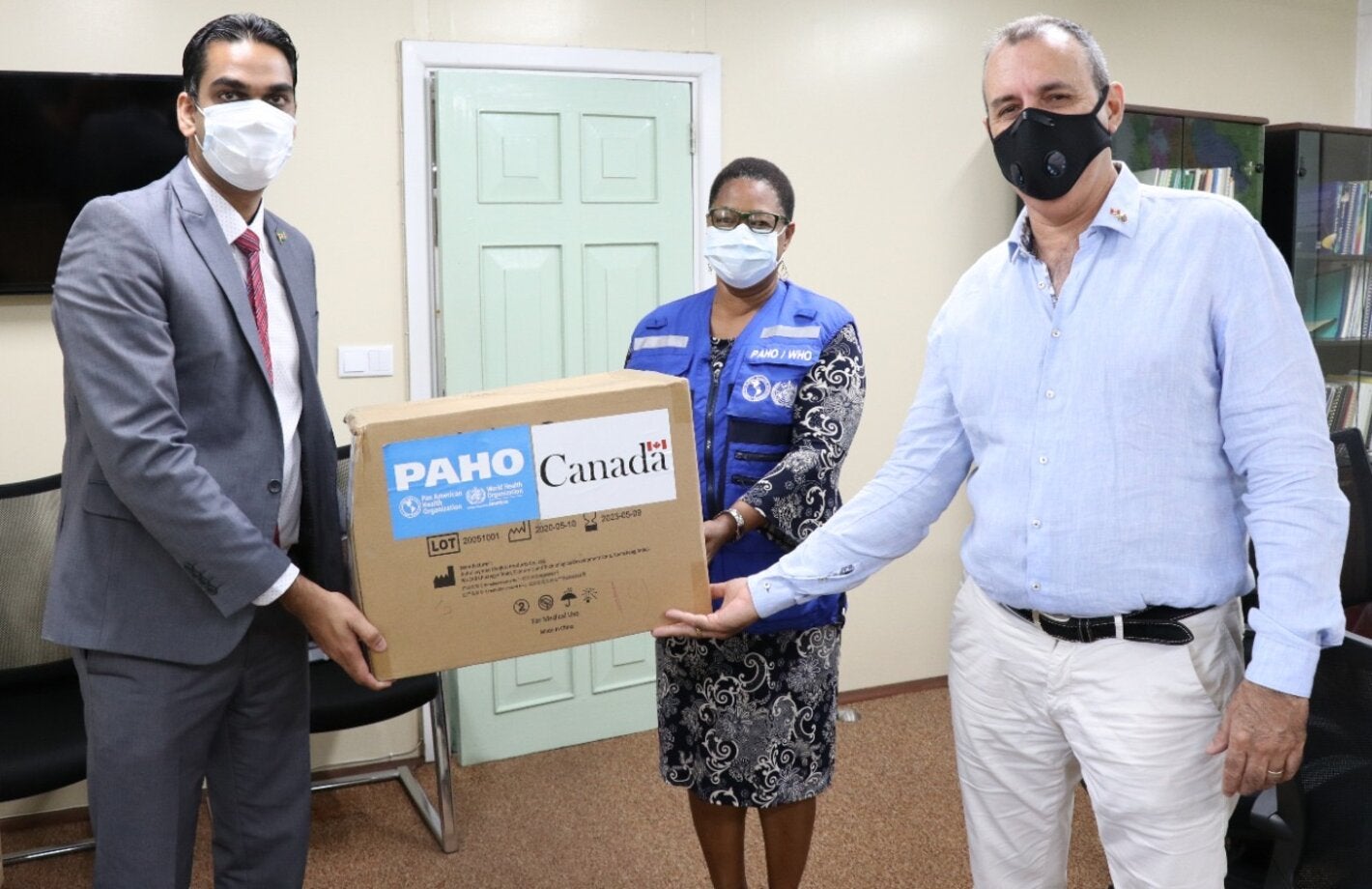 Minister of Health, Dr. Amar Ramadhin accepts the personal protective equipment provided by PAHO/WHO and the Government of Canada