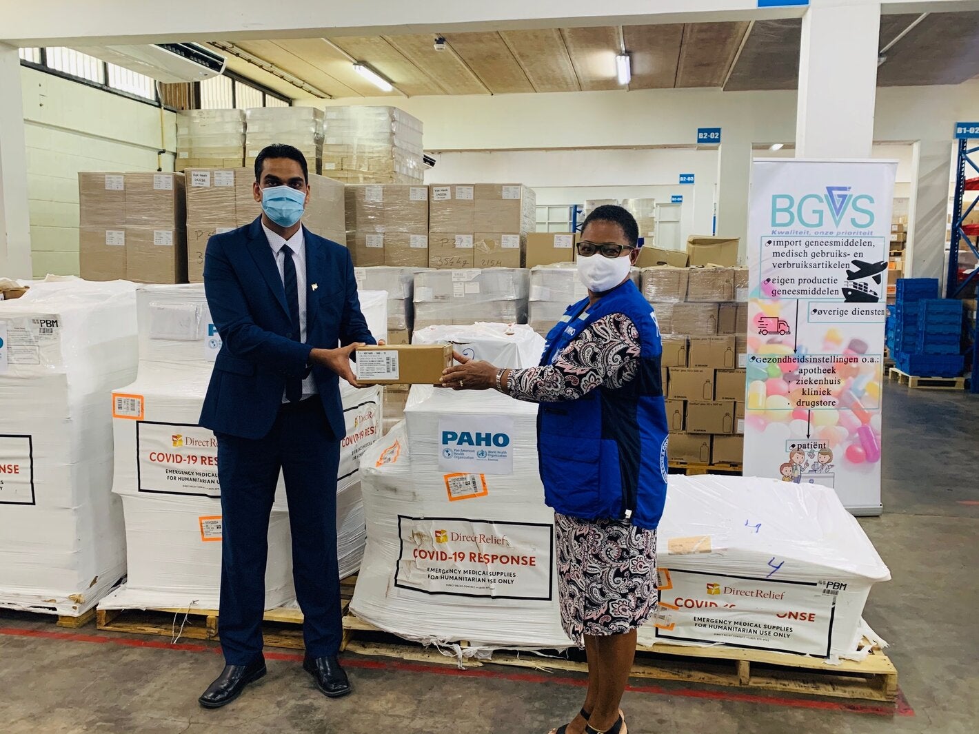 Dr. Karen Lewis-Bell, PAHO/WHO Representative in Suriname hands over a donation of COVID-19 supplies for case management to Dr. Amar Ramadhin, Minister of Health